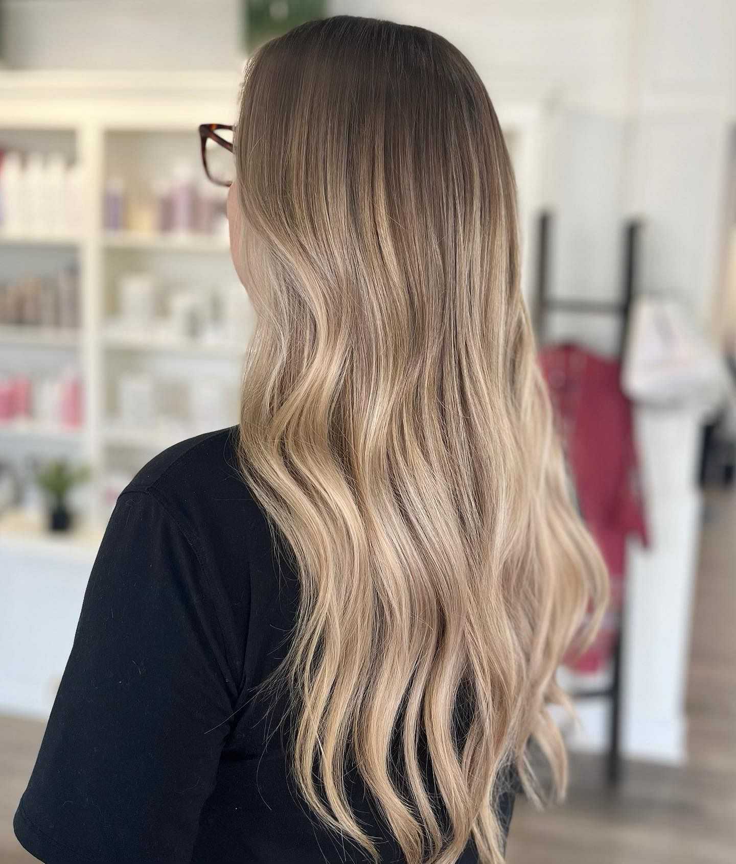 Person with long, wavy ombre hair, viewed from behind.